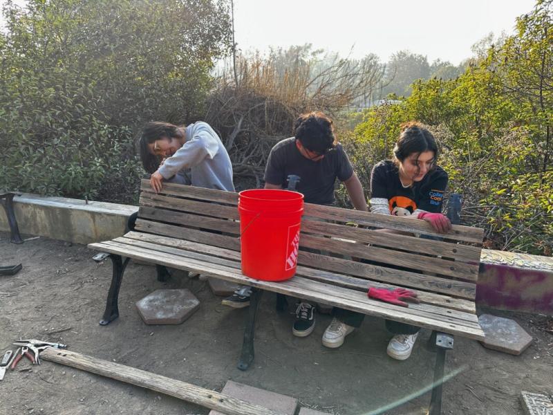 Fellows fixing a bench.
