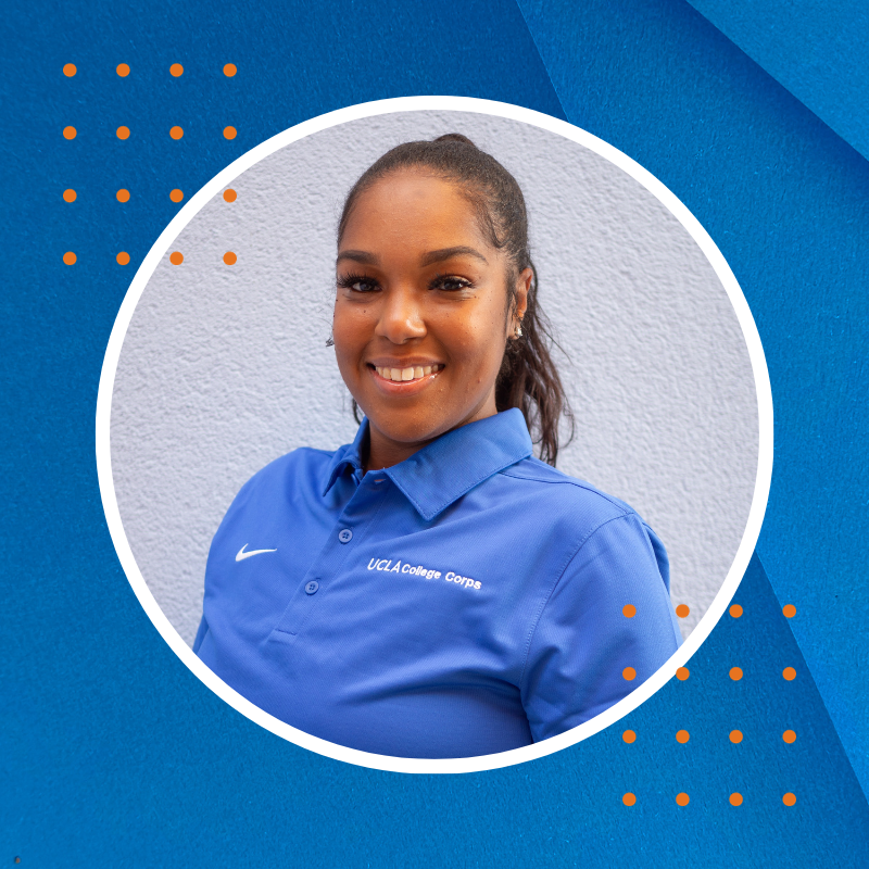 A smiling Black woman, with dark brown hair, in a blue shirt