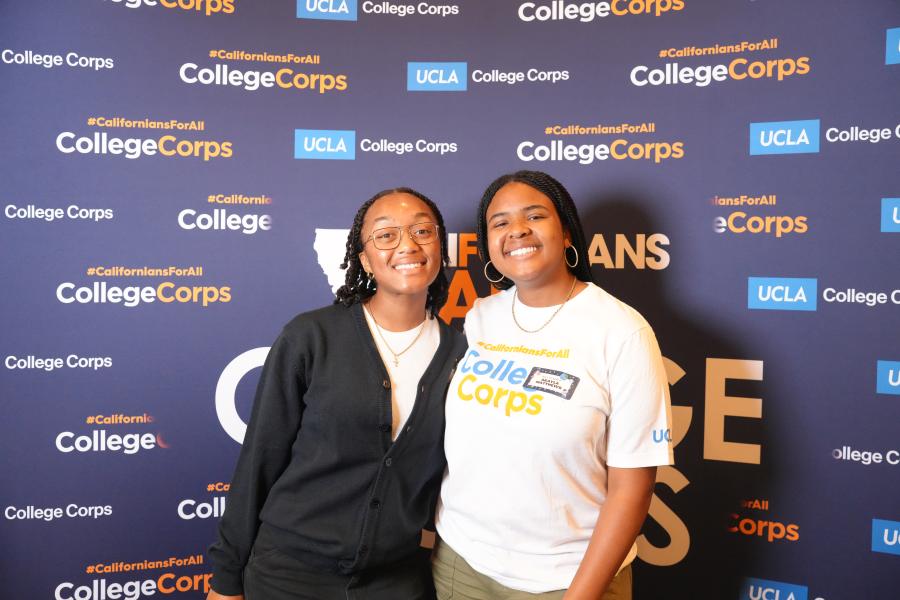 Two students smiling at the camera 